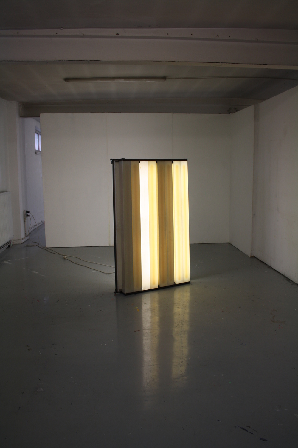 Dennis Ramaekers - A series of lights and light conductors / first form 2011 The main elements for this work were found in, and used to be part of, the building where the piece was presented. Old lamp covers and discarded fluorescent lamps from different periodes in the buildings history, were combined into one light object.