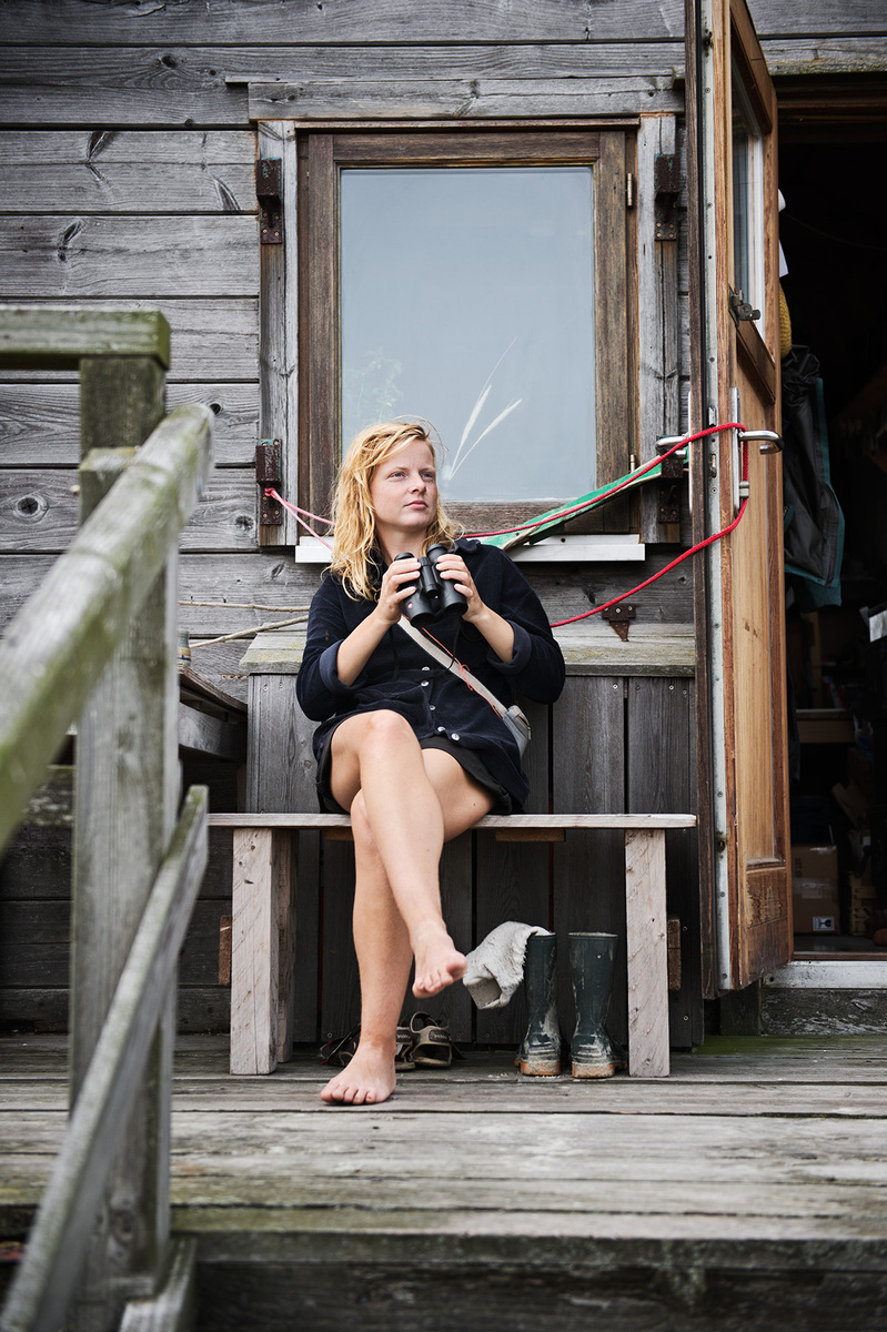 Mareike Timm | Photo Journalist - From her porch, Anne de Walmont keeps an eye out for birds visiting the island.