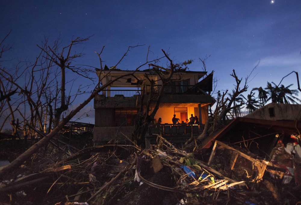 John T. Pedersen Photography - 2013 They survived In the shelter of the night A house in the ruins that was not taken by the typhoon.