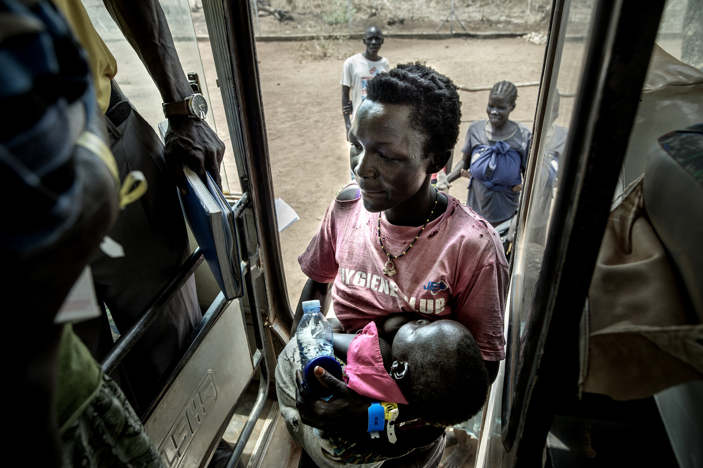 John T. Pedersen Photography - The locals often notify the authorities in the border area when they see the refugees coming out from the jungle trails. Then they are sent to temporary gathering spots located in the border areas. BidiBidi is not a refugee camp where refugees are placed inside an area covered with barbed wire fence. Its a settlement for refugees. Here they can move freely as they wish. After registering they are provided with a tent from the UN and a small land patch where they can grow their own food. In the Goboro center they get emergency medical help, as well as given food and water supplies. Many of them have been walking for days, without getting any nutrition.