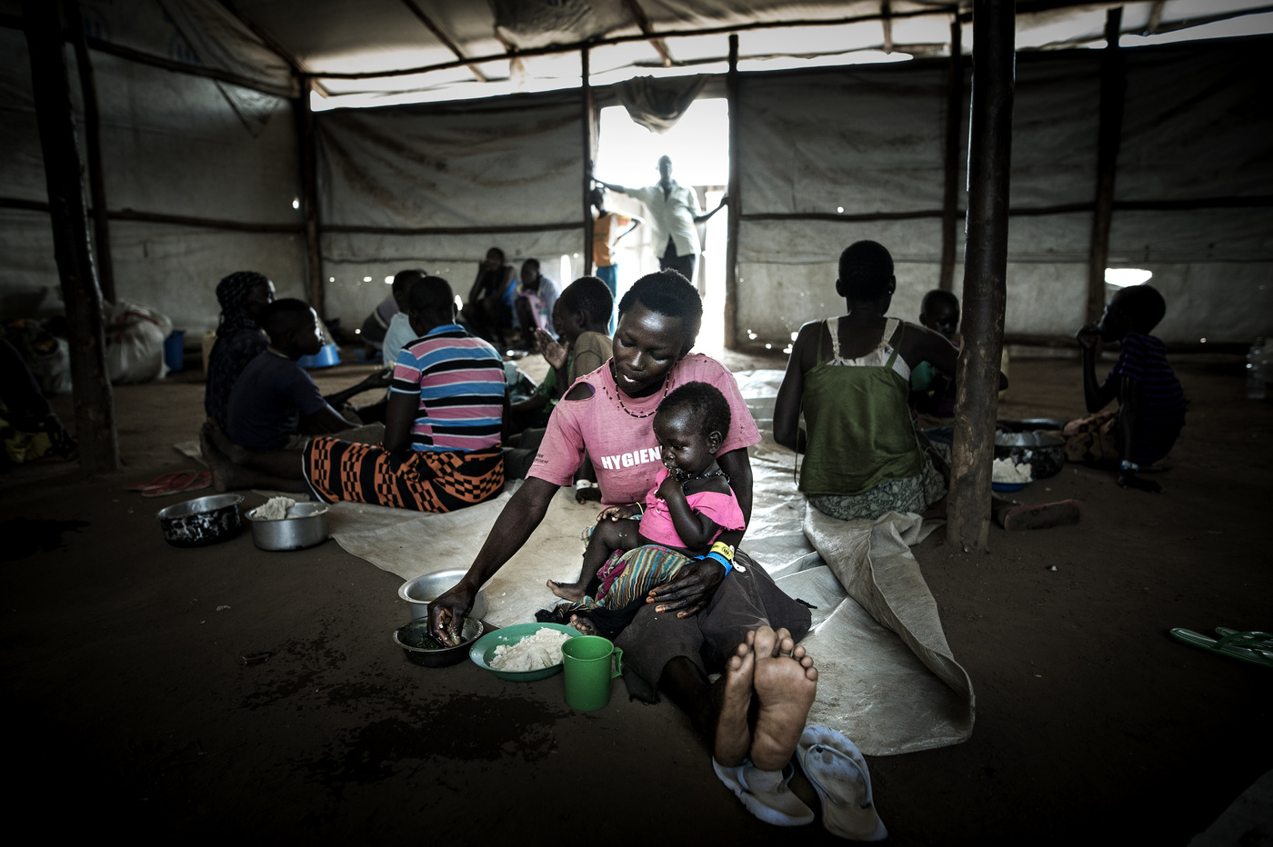 John T. Pedersen Photography - Walking for one week along the road in the strong heat, carrying on her child, and nothing else than the clothes she’s is wearing, Jenneth has finally made it to the border. I did see many dead and abused bodies on the way. It was stressful and constantly to be alert to dangers, always being prepared to run into the jungle for hiding. Her village of Kajo-Keji in South Sudan is far away by now.