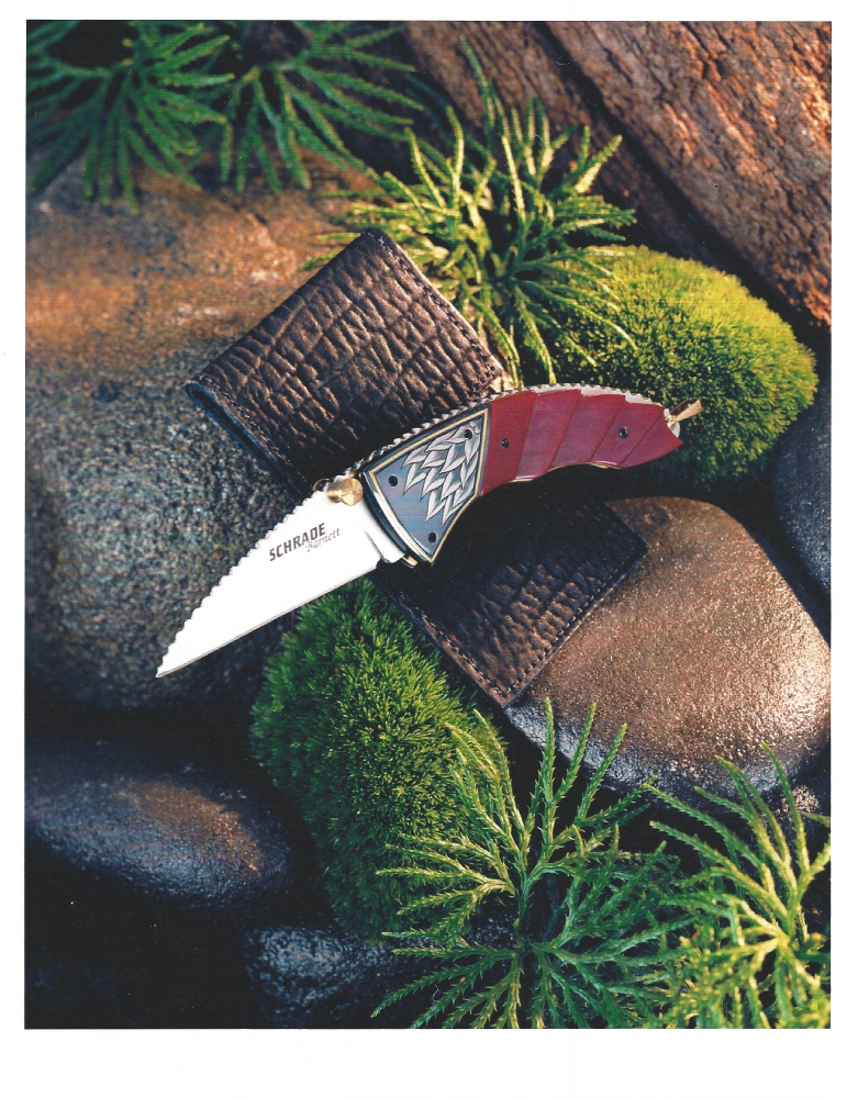 The Art of Van Barnett - Schrade/Barnett - this won Blade Magazines Knife of the Year award for best Factory Collaboration in 2001. Schrade told me it was their only Blade Magazine knife of the year award. Some of the innovative processes that Schrade invented to manufacture this piece with all of its carving and filework, were some of the first in the Factory knife industry at that time. There were two of these knives, one red and one green. There were only 1000 of each and only 500 marked first production run. They are quite valuable on the after-market now. There are about 10 or so that were hand signed by me by engraving my signature on the blades, and also signing all the extra materials, like the leather sheath, zip pouch, box and paperwork. Sadly, a few years after this, Schrade closed after 100 years of producing millions of knives that were sold world wide.